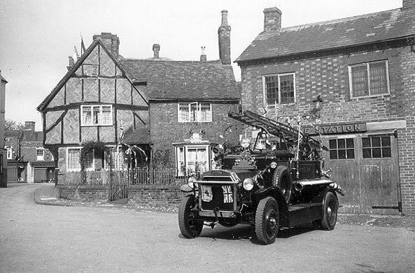 Fire engine with flags outside fire station